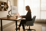 Professional using gray laptop in modern home office