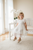 Toddler girl wearing gold ballerina Mary Jane dress shoes