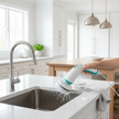 Electric spin scrubber cleaning kitchen sink and countertop